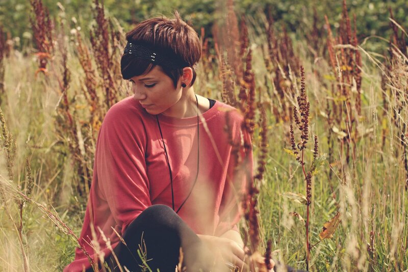 woman in a field of tall grass