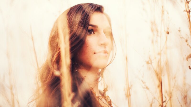 woman in a field of tall grass