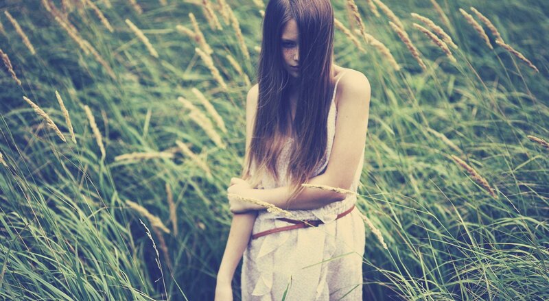 woman in a field of tall grass