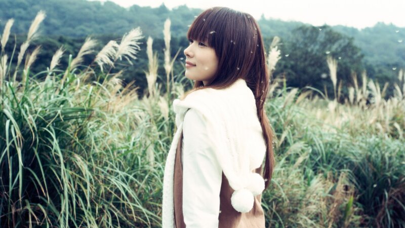 woman in a field of tall grass