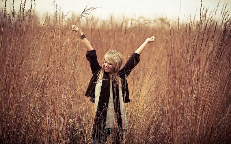woman in a field of tall grass