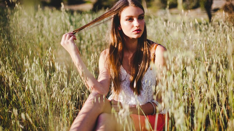 woman in a field of tall grass
