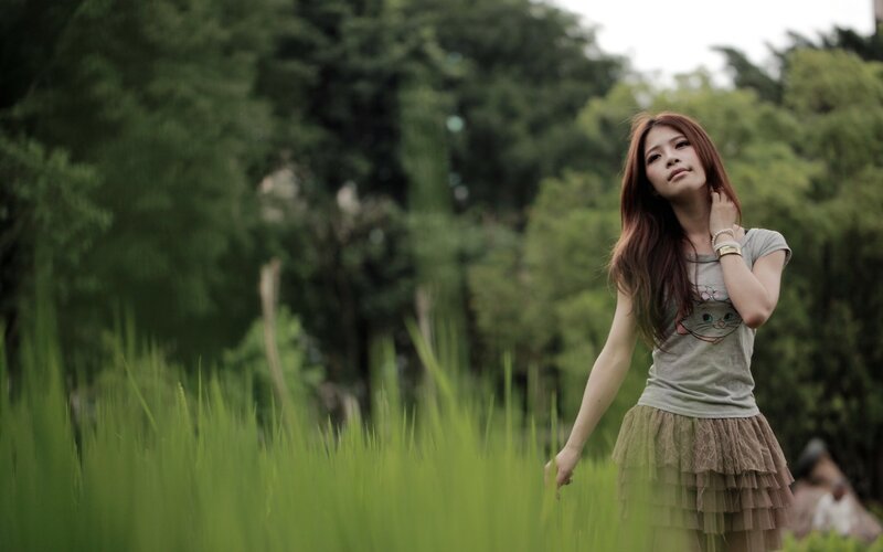 woman in a field of tall grass