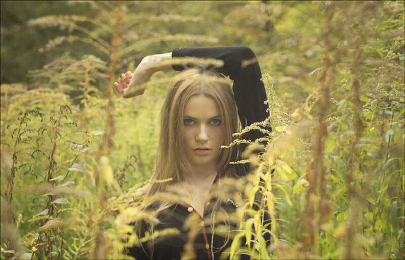 woman in a field of tall grass