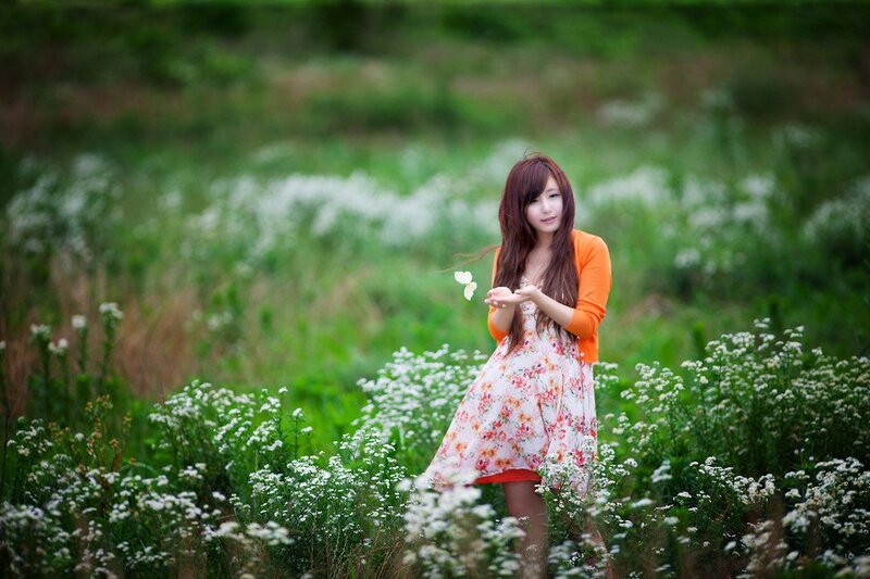 Woman in a field of white flowers