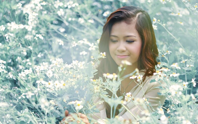 woman in a field of white flowers