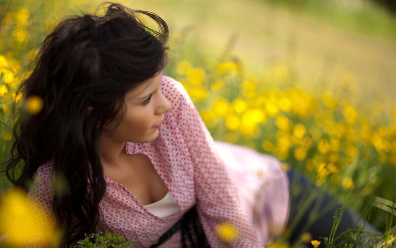 woman in a field of yellow flowers