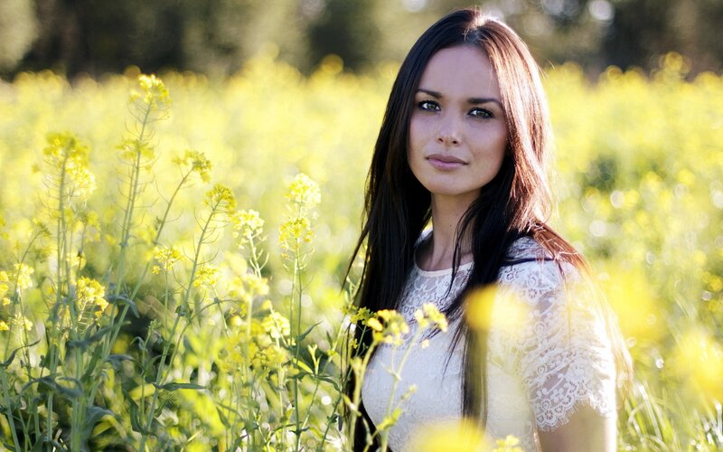 woman in a field of yellow flowers