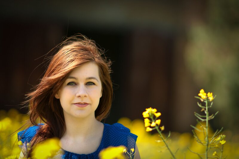 woman in a field of yellow flowers