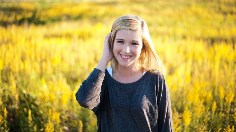 woman in a field of yellow flowers