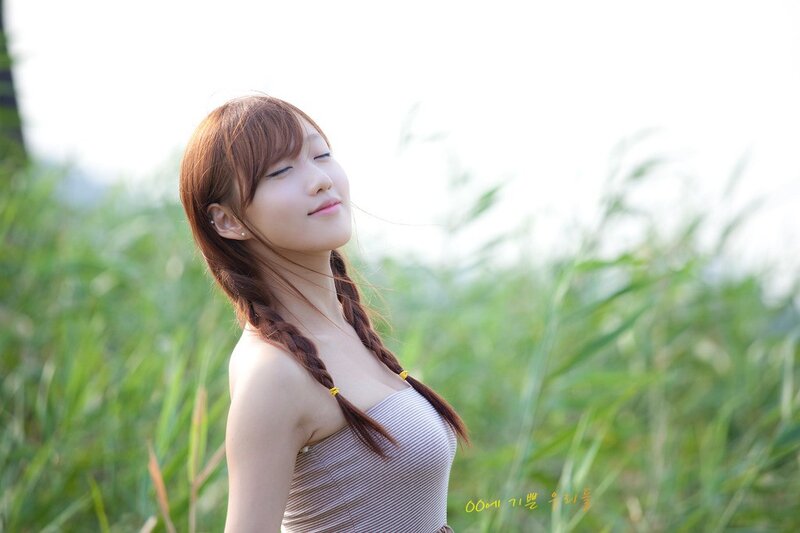 Woman in a field with braids