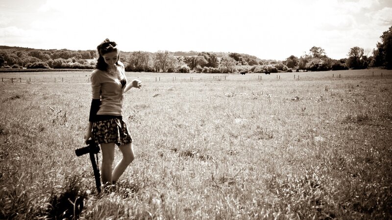 Woman in a field with camera