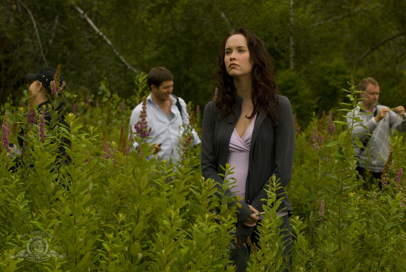 Woman in a field with crew