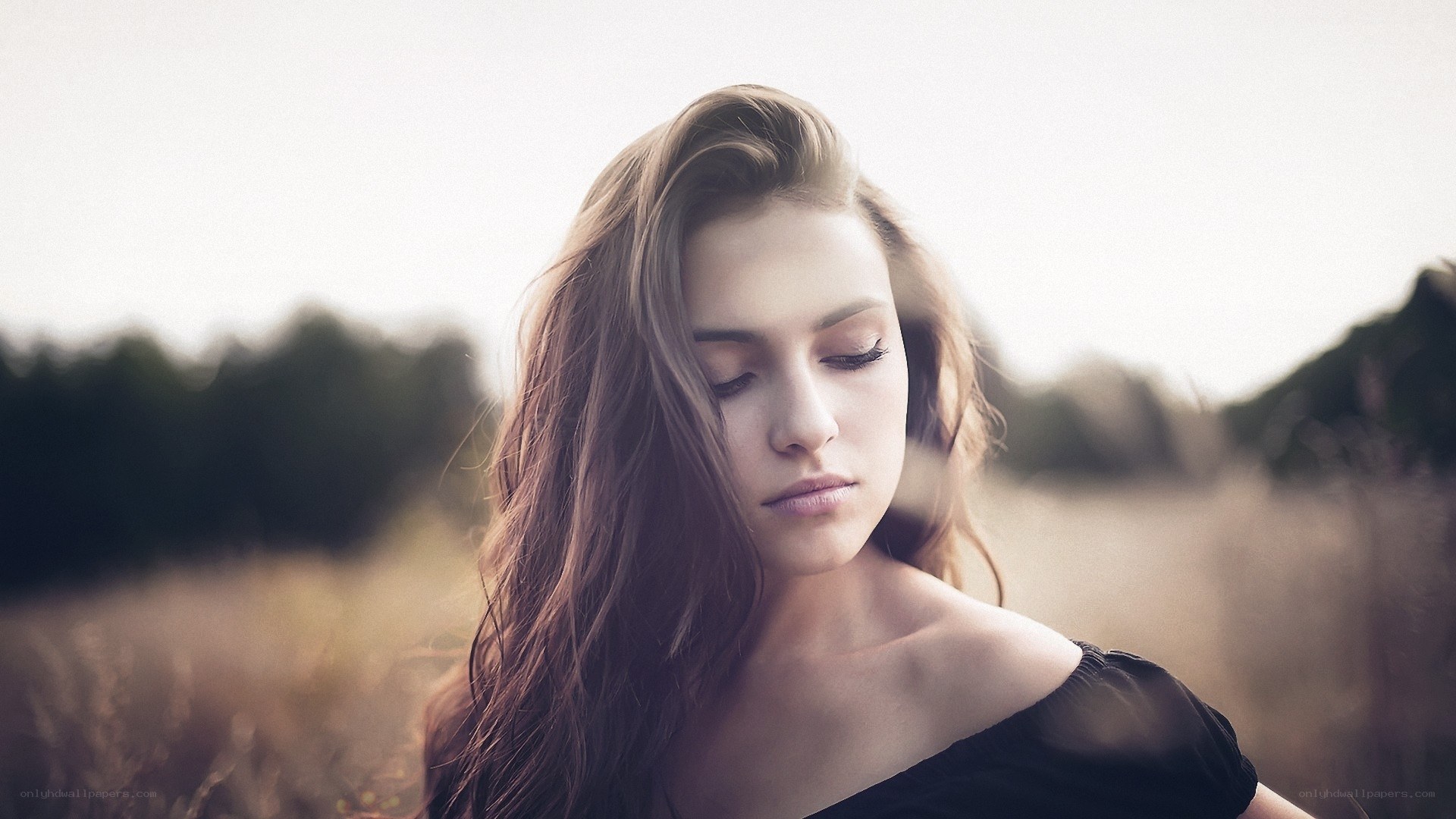 woman in a field with eyes closed