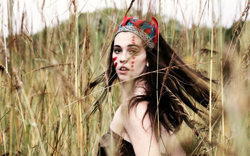 woman in a field with face paint