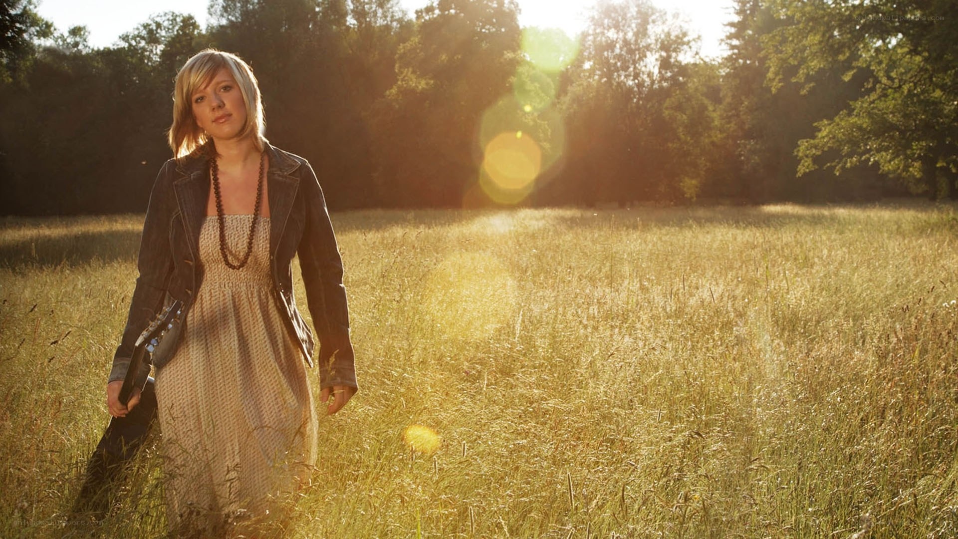 Woman in a field with guitar
