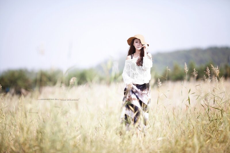 Woman in a field with hat