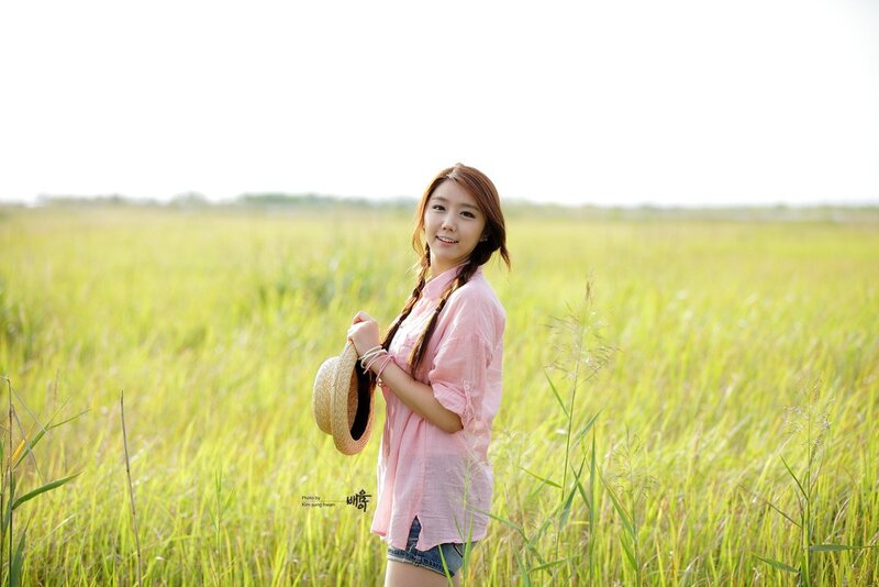Woman in a field with hat