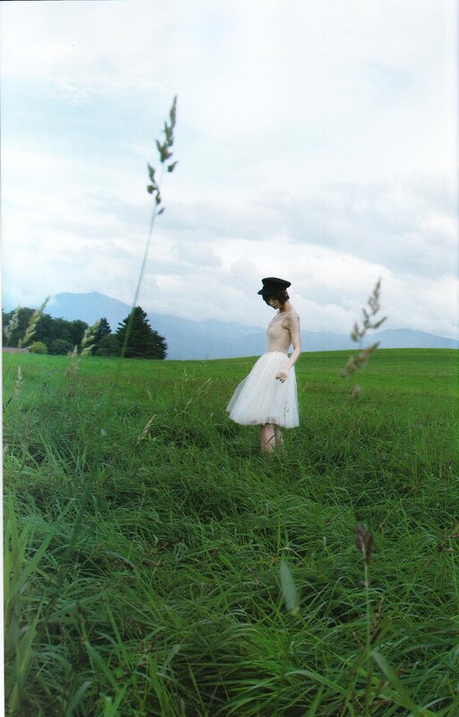 Woman in a field with mountains