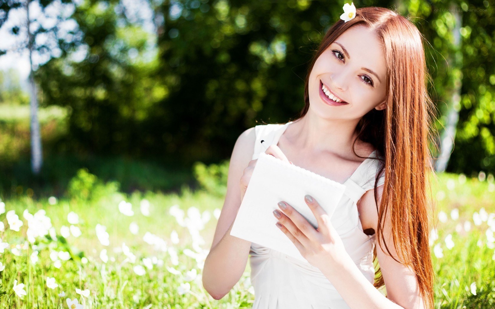 Woman in a field with notebook