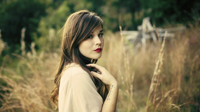 woman in a field with red lipstick