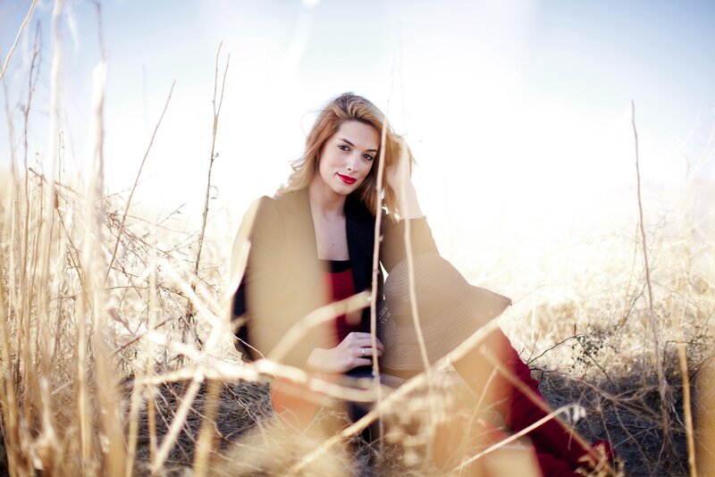 woman in a field with sun flare