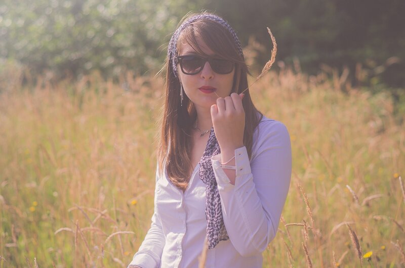 Woman in a field with sunglasses
