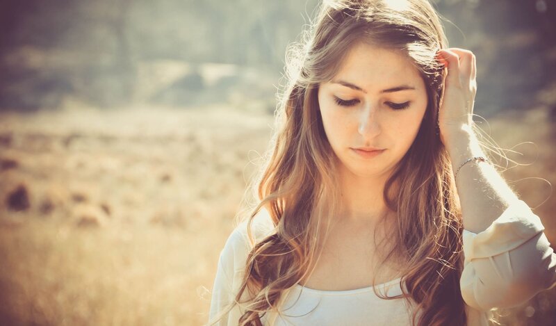 woman in a field with sunlight
