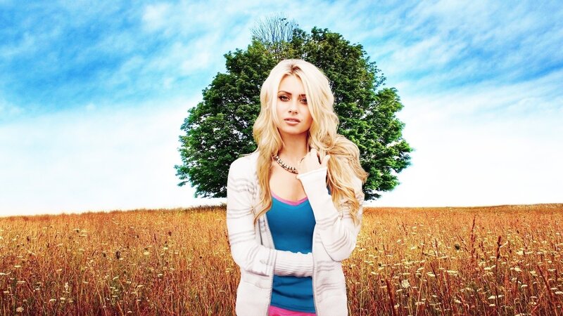 woman in a field with tree
