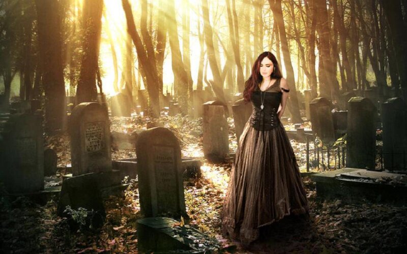 woman in a graveyard at sunset