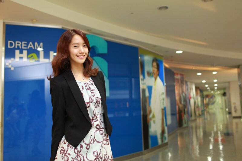 woman in a hallway smiling