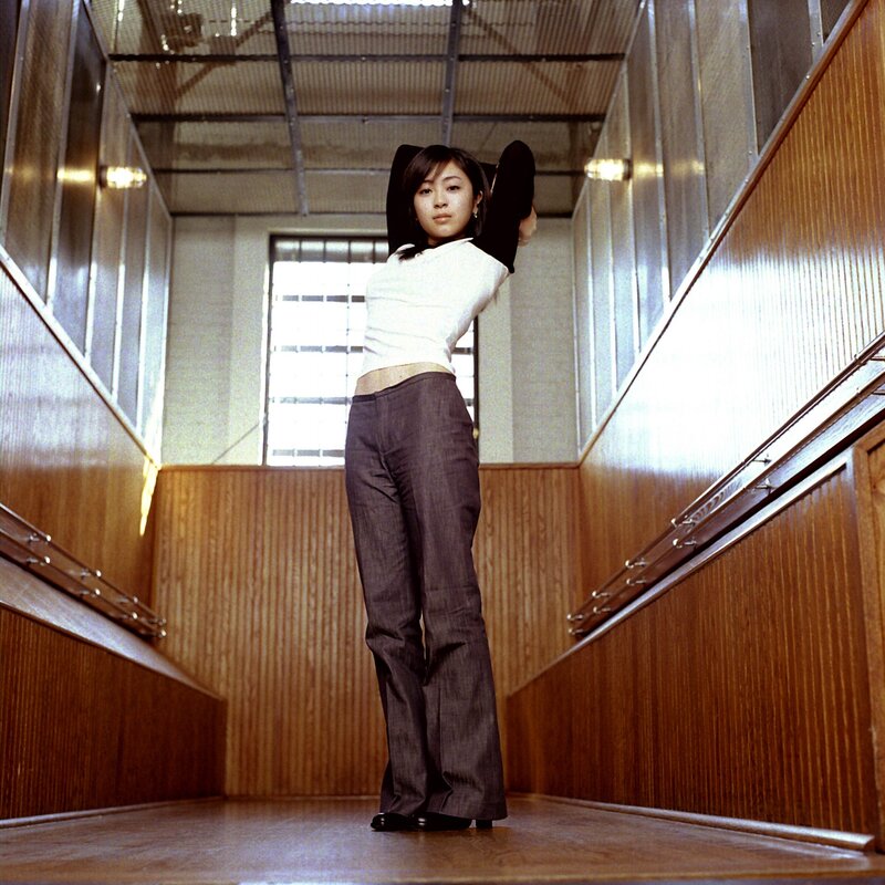 woman in a hallway stretching