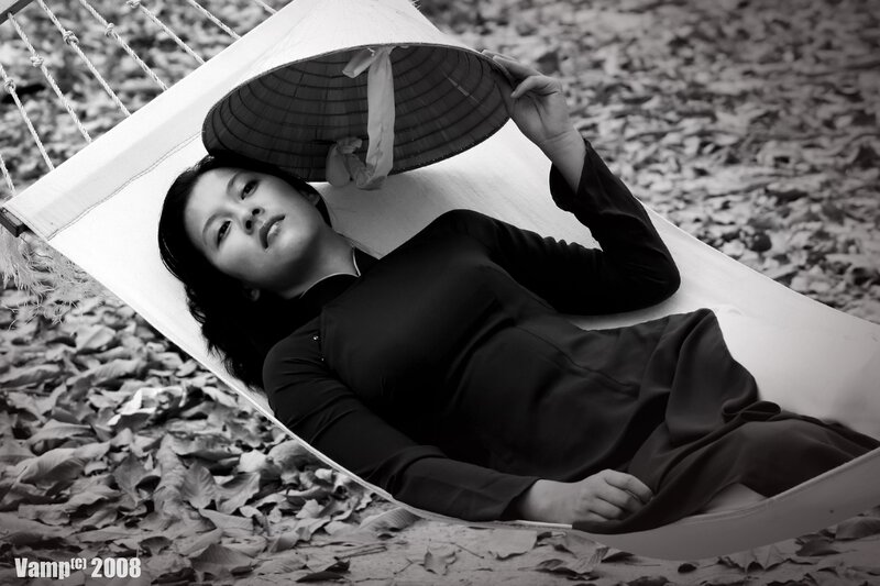 Woman in a hammock with conical hat