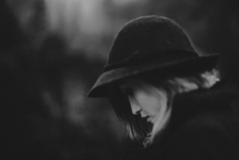 woman in a hat looking down