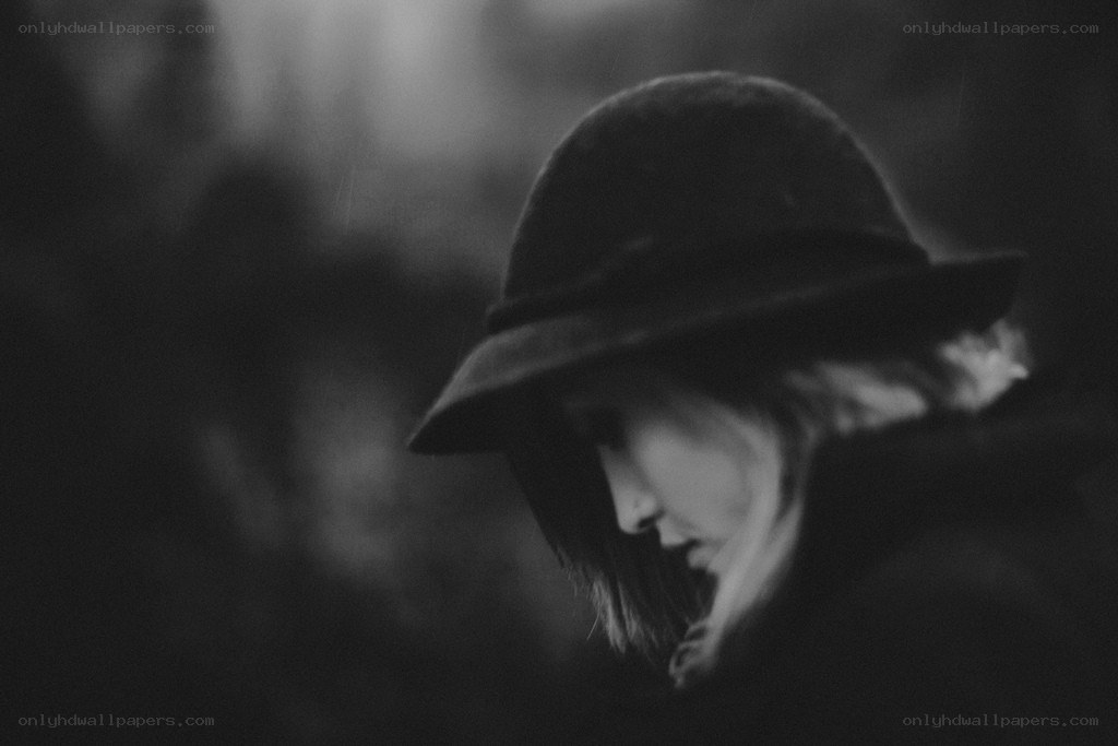 woman in a hat looking down