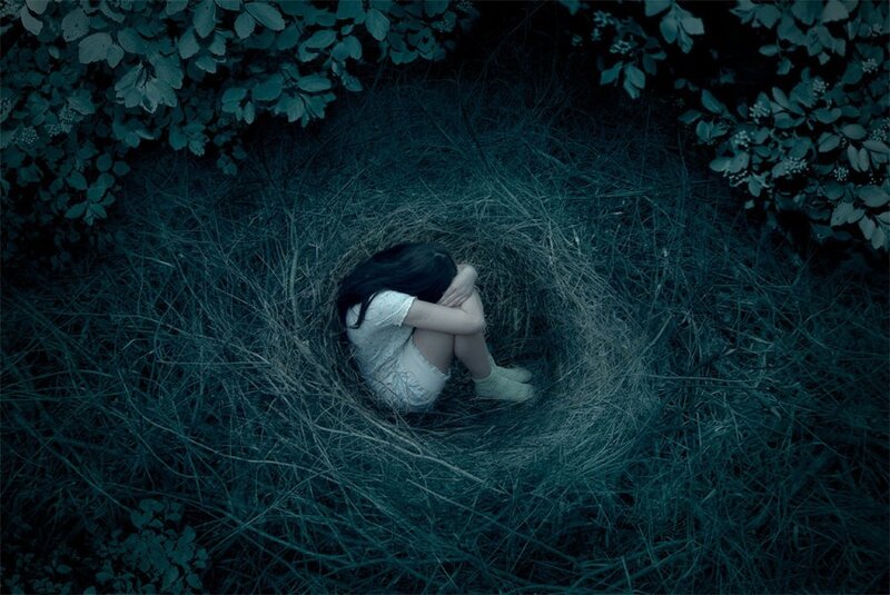 woman in a nest of grass