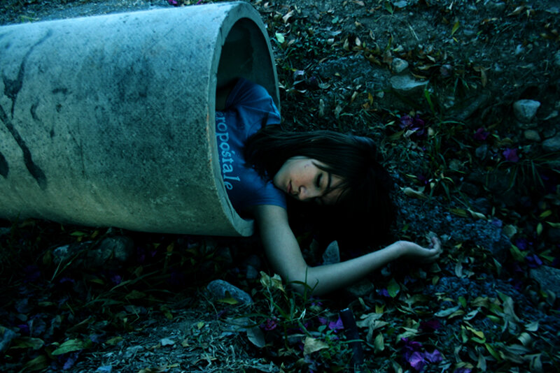 Woman in a pipe outdoors