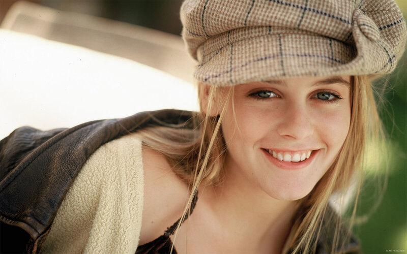 woman in a plaid hat smiling