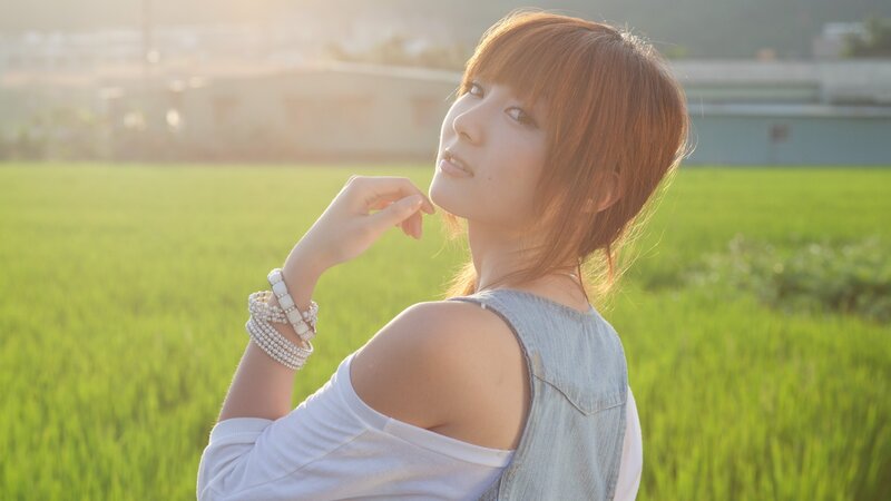woman in a rice field at sunset