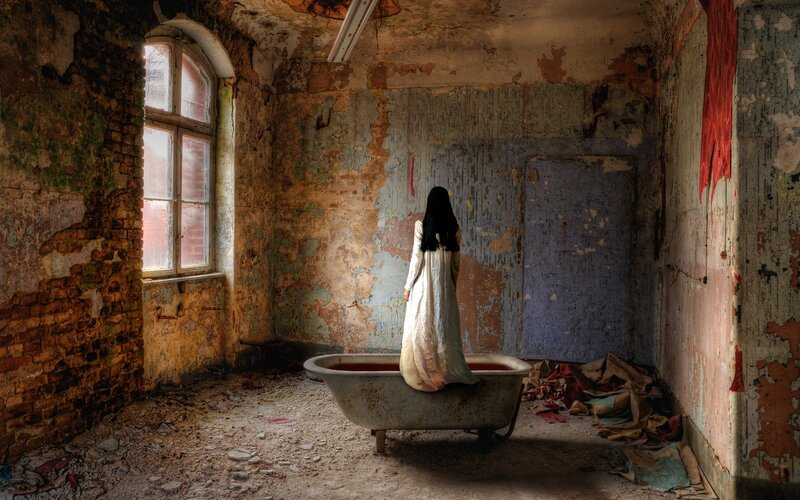 Woman in a ruined bathroom