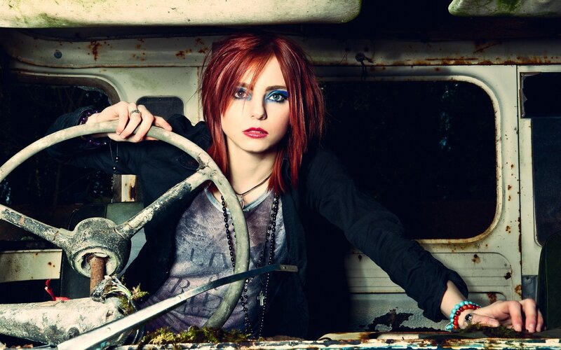 woman in a rusty car