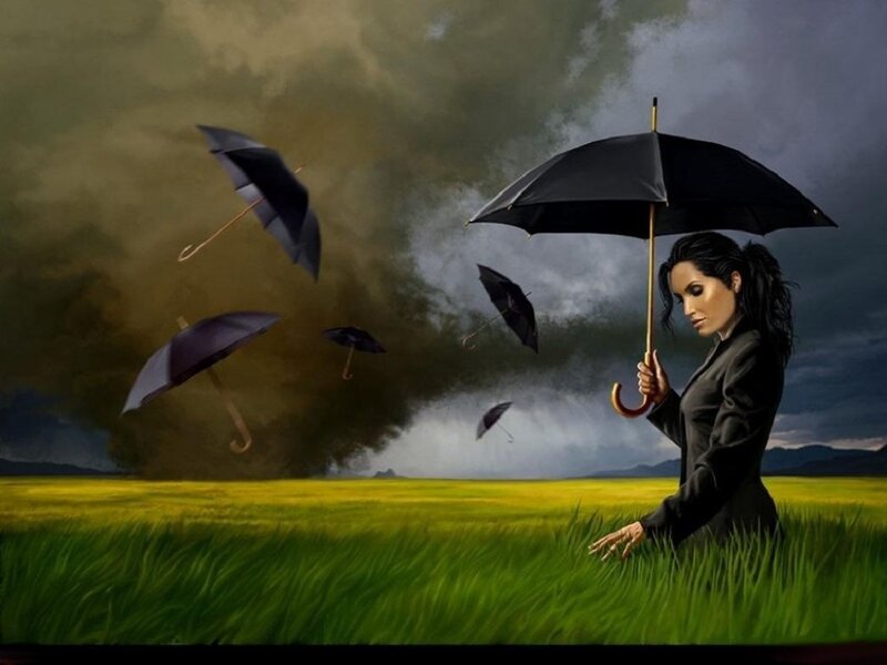 Woman in a storm with umbrellas