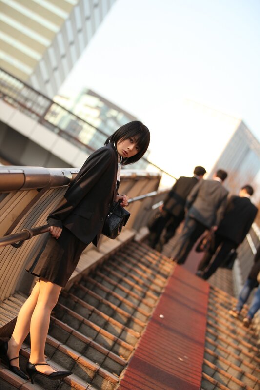 Woman in a suit on stairs