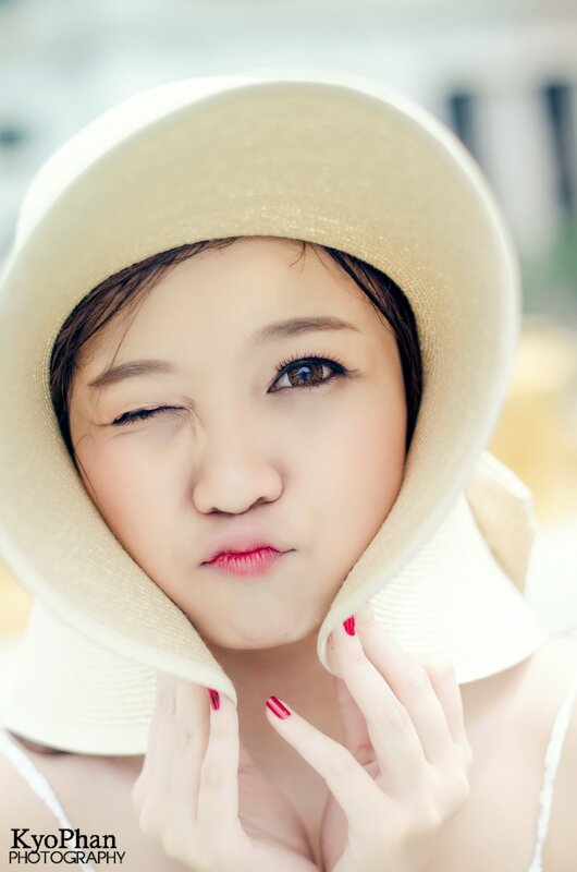 woman in a sun hat winking