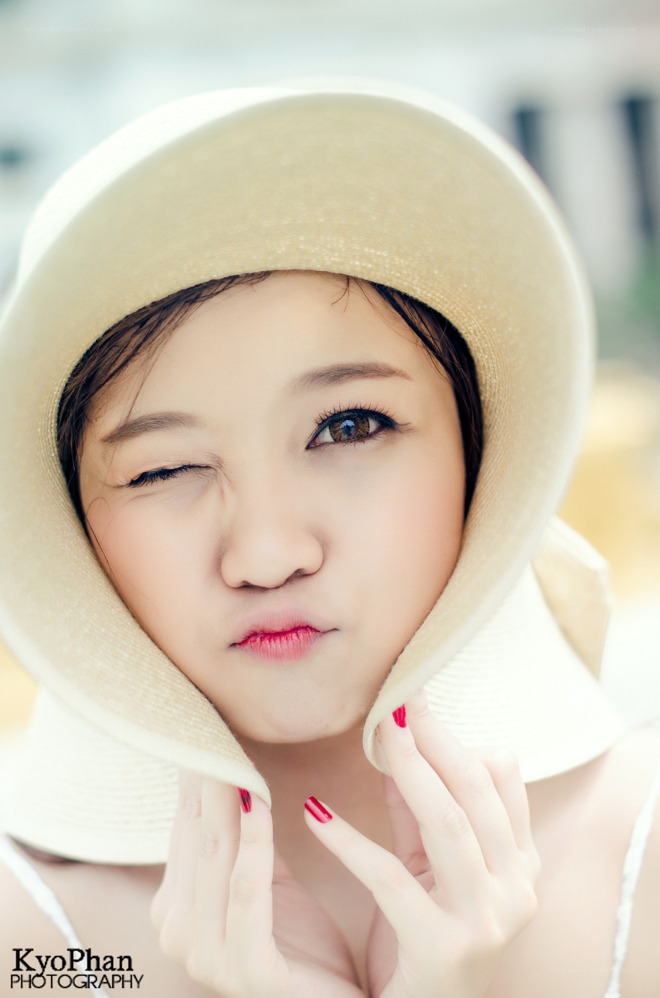woman in a sun hat winking
