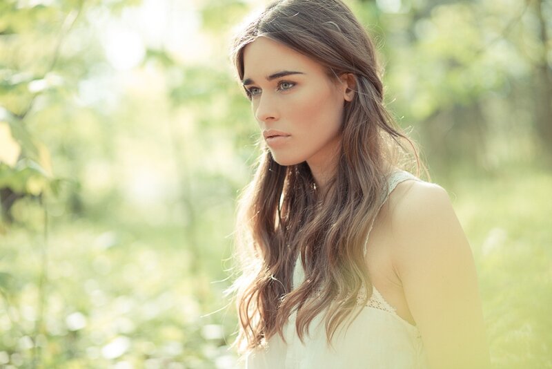 woman in a sunlit forest