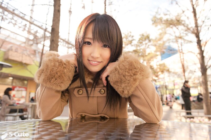 Woman in a tan coat outdoors