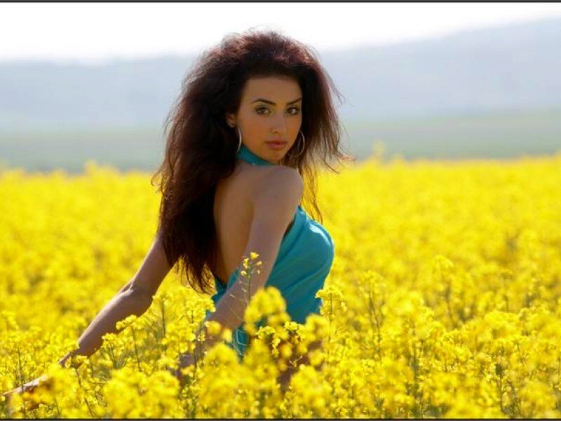 woman in a yellow flower field