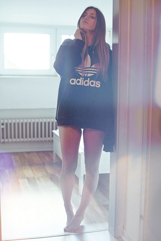 woman in adidas sweatshirt