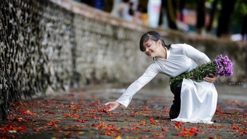 Woman in ao dai with flowers